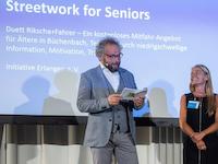 Two people at an award ceremony.